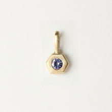 Load image into Gallery viewer, 14k yellow gold pendant with a light purple tanzanite gemstone shown on a light gray background. Talāyee Fine Jewelry Hexad Charm