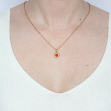 Load image into Gallery viewer, A round gold pendant featuring a textured raised border and a central carnelian cabochon gemstone, shown on figure. Talayee Fine Jewelry's Atousa Medallion Pendant.