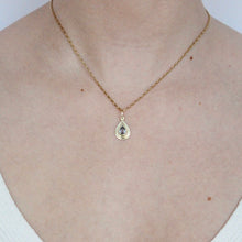 Load image into Gallery viewer, talayee fine jewelry's persepolis pendant featuring a light blue pear cut sapphire set in 18k gold shown on figure