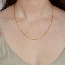 Load image into Gallery viewer, 14k yellow gold 1.2mm wide cable chain by Talāyee Fine Jewelry on figure