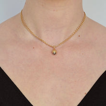 Load image into Gallery viewer, Talayee Fine Jewelry's Atousa Bell Pendant featuring a diamond cabochon set in 18k gold with the signature texture design shown worn on a chain on figure