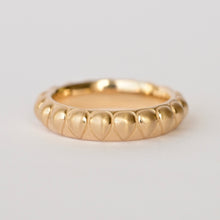 Load image into Gallery viewer, A gold band ring with a textured raised pear shape pattern, photographed on a clean white background. Talayee Fine Jewelry's Atousa Ring.