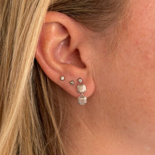 Load image into Gallery viewer, Close-up of an ear with geometric drop earrings called the Persepolis Drops by Talayee Fine Jewelry