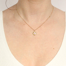 Load image into Gallery viewer, Talayee Fine Jewelry's domed charm pendant with a garnet flush set in 14k yellow gold on figure