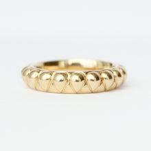 Load image into Gallery viewer, A gold band ring with a textured raised pear shape pattern, photographed on a clean white background. Talayee Fine Jewelry's Atousa Ring.