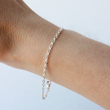 Load image into Gallery viewer, silver infinity chain bracelet shown on wrist against a white background
