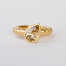 Load image into Gallery viewer, Talayee Fine Jewelry's Atousa Bezel Ring featuring a pear shaped golden zircon bezel set in 18k gold on the signature textured band shown on a white background