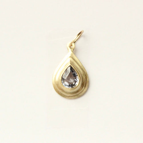 talayee fine jewelry's persepolis pendant featuring a light blue pear cut sapphire set in 18k gold shown on a white background
