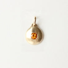 Load image into Gallery viewer, 14k yellow gold round pendant with an orange montana sapphire center flush set shown on a white background
