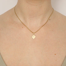 Load image into Gallery viewer, 14k gold charm in a geometric shape on a a barleycorn chain shown on figure. Handmade find jewelry in San Francisco.
