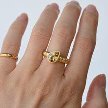 Load image into Gallery viewer, Talayee Fine Jewelry's Atousa Bezel Ring featuring a pear shaped golden zircon bezel set in 18k gold on the signature textured band shown worn on a hand
