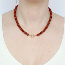 Load image into Gallery viewer, 14k gold round charm clasp shown on a beaded necklace on figure
