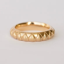 Load image into Gallery viewer, A gold band ring with a textured raised pear shape pattern, photographed on a clean white background. Talayee Fine Jewelry's Atousa Ring.
