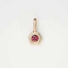 Load image into Gallery viewer, 14k yellow gold hexagonal pendant with a pink garnet gemstone shown on a white background. Talayee Fine Jewelry Hexad Charm.
