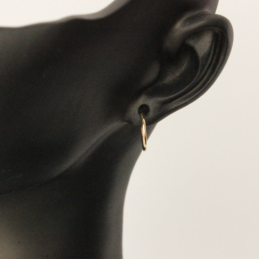 14k gold flexible tube hoops on mannequin