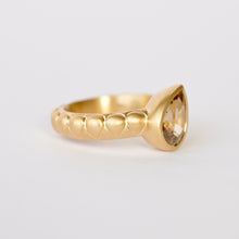 Load image into Gallery viewer, Talayee Fine Jewelry's Atousa Bezel Ring featuring a pear shaped golden zircon bezel set in 18k gold on the signature textured band shown on a white background
