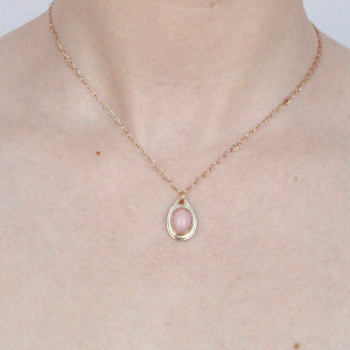 Talayee fine jewelry's persepolis pendant featuring a pink opal set in 14k gold on figure