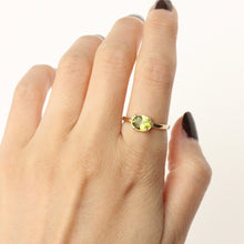 Load image into Gallery viewer, 14k gold and peridot solitaire ring on model. handmade in san francisco by talayee fine jewelry
