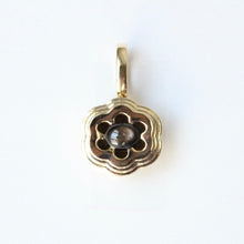 Load image into Gallery viewer, 14k Bloom pendant with a central black star sapphire gemstone on a white background
