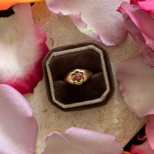 Load image into Gallery viewer, Talayee Fine Jewelry&#39;s Bloom Ring. 18k Yellow Gold ring with a pink tourmaline in a flower setting shown on a brown velvet cushion surrounded by pink petals.

