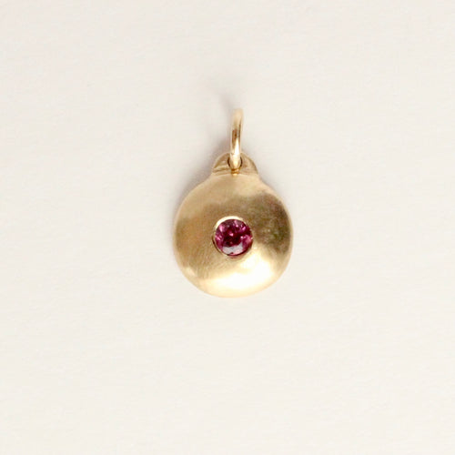 Talayee Fine Jewelry's domed charm pendant with a garnet flush set in 14k yellow gold