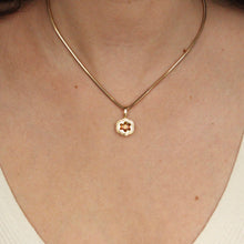 Load image into Gallery viewer, Talayee Fine Jewelry&#39;s Bloom Pendant. 18k yellow gold pendant with an orange garnet set in a floral style setting styled on a snake chain shown on figure.
