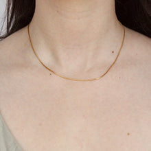 Load image into Gallery viewer, 16 inch 1.2mm wide snake chain in 14k yellow gold on figure
