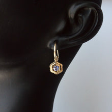 Load image into Gallery viewer, talayee fine jewelry's 14k yellow gold bloom earrings with a tanzanite shown on figure against a white background
