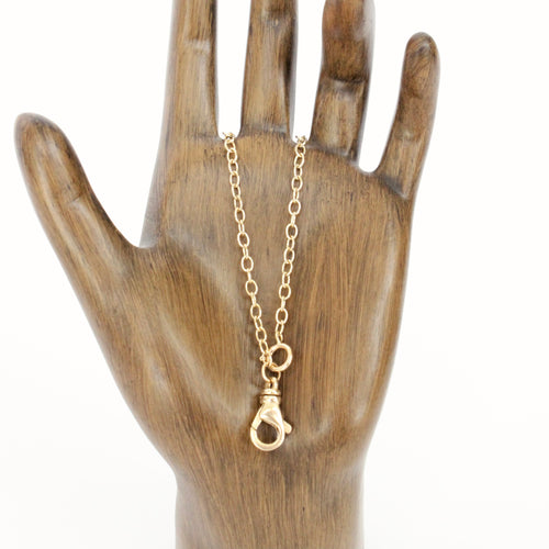 14k yellow gold charm chain necklace with lobster clasp on figure