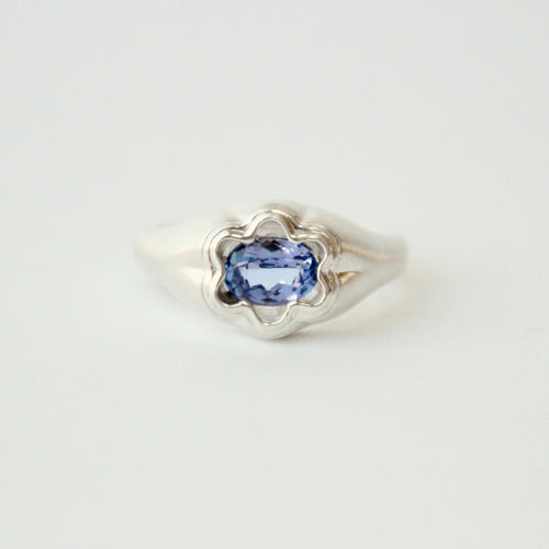sterling silver Bloom ring by Talayee Fine Jewelry set with a Tanzanite on a grey background