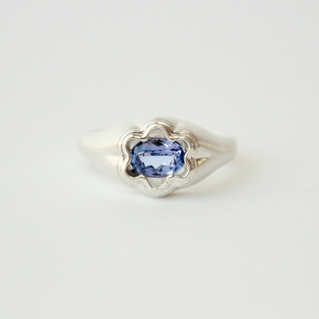 sterling silver Bloom ring by Talayee Fine Jewelry set with a Tanzanite on a grey background
