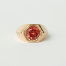 Load image into Gallery viewer, A 14k gold signet ring featuring a round malaya garnet, photographed on a clean, light off-white background.
