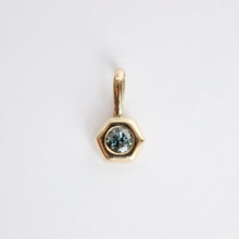 Load image into Gallery viewer, 14k yellow gold charm set with a round gray spinel on a light gray background
