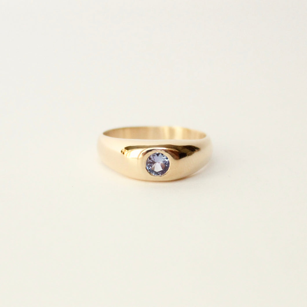 Talayee Fine Jewelry's signature Juno flush set gemstone dome ring with a tanzanite set in 14k gold. Cool girl engagement rings for her and for him.