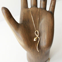 Load image into Gallery viewer, 14k gold 16&quot; long snake necklace on wooden hand display. cheap real gold jewelry san francisco.

