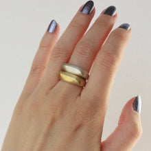 Load image into Gallery viewer, 14k gold and sterling silver statement ring stacked on hand.
