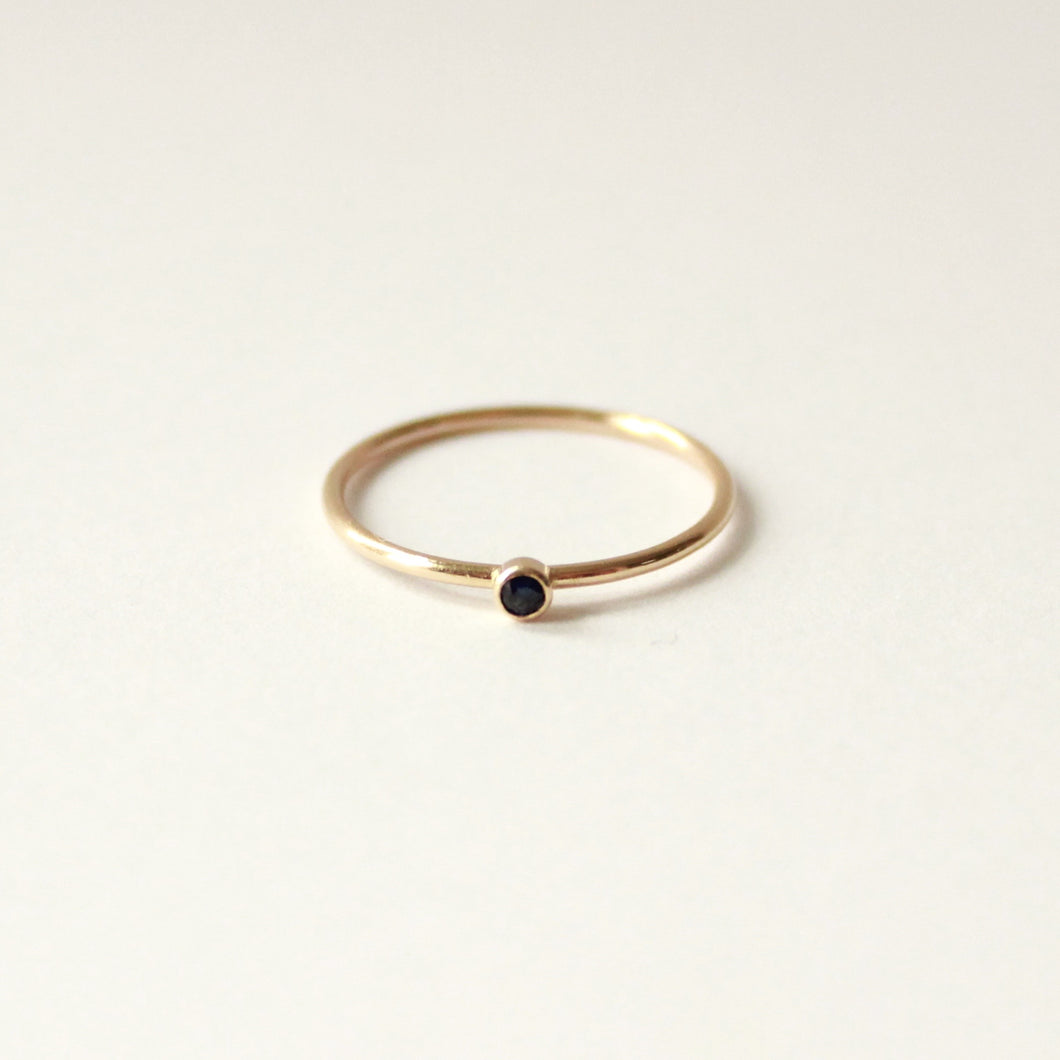 the littlest stacking ring. small sapphire set in a vow ring on white background.