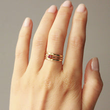 Load image into Gallery viewer, 3 piece vow ring set on figure with garnet center
